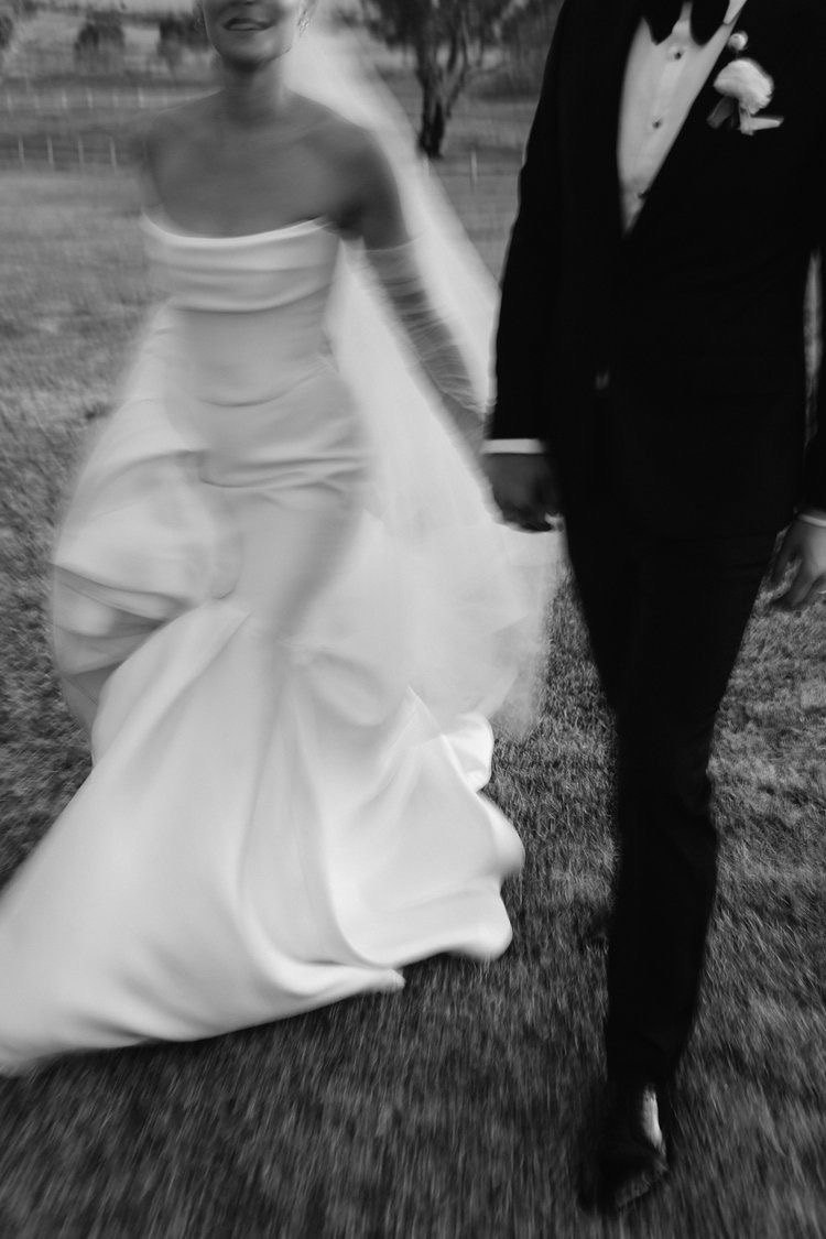 A bride and groom walking hand in hand